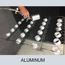 Load image into Gallery viewer, Metal couplings sprayed with Zycoat products resting on a drying rack