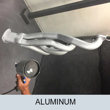 Load image into Gallery viewer, 4 cylinder engine exhaust pipes being sprayed with the zycoat aluminum finish product